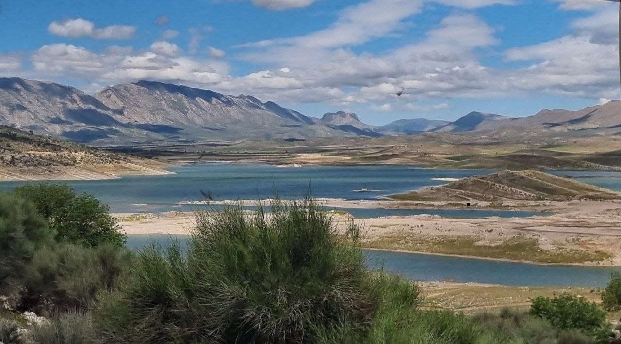 Water and mountain slopes seen from the bus.