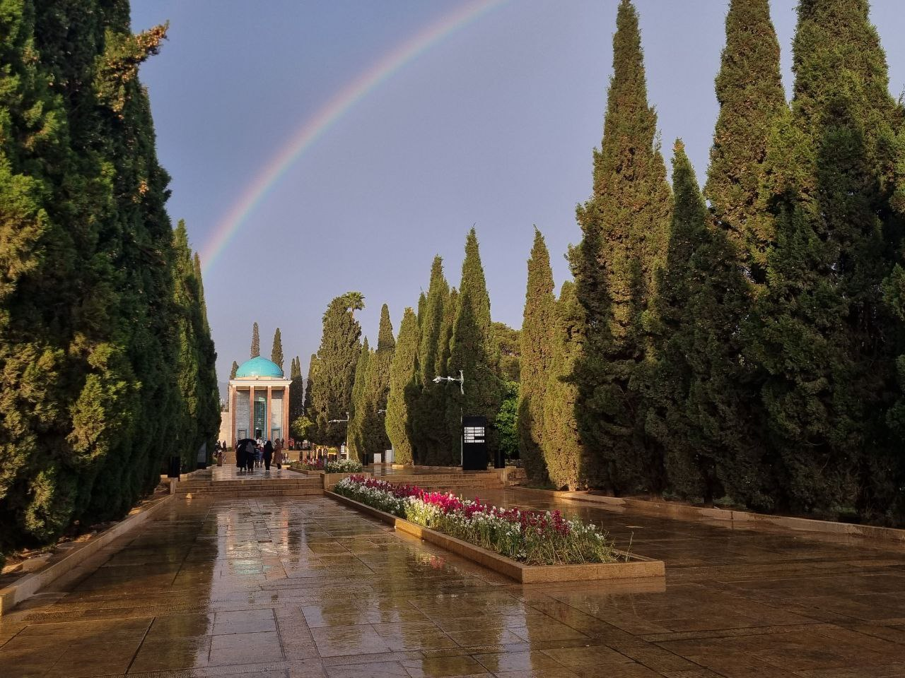 Saadi’s tomb — a rainbow above the wet garden paths.