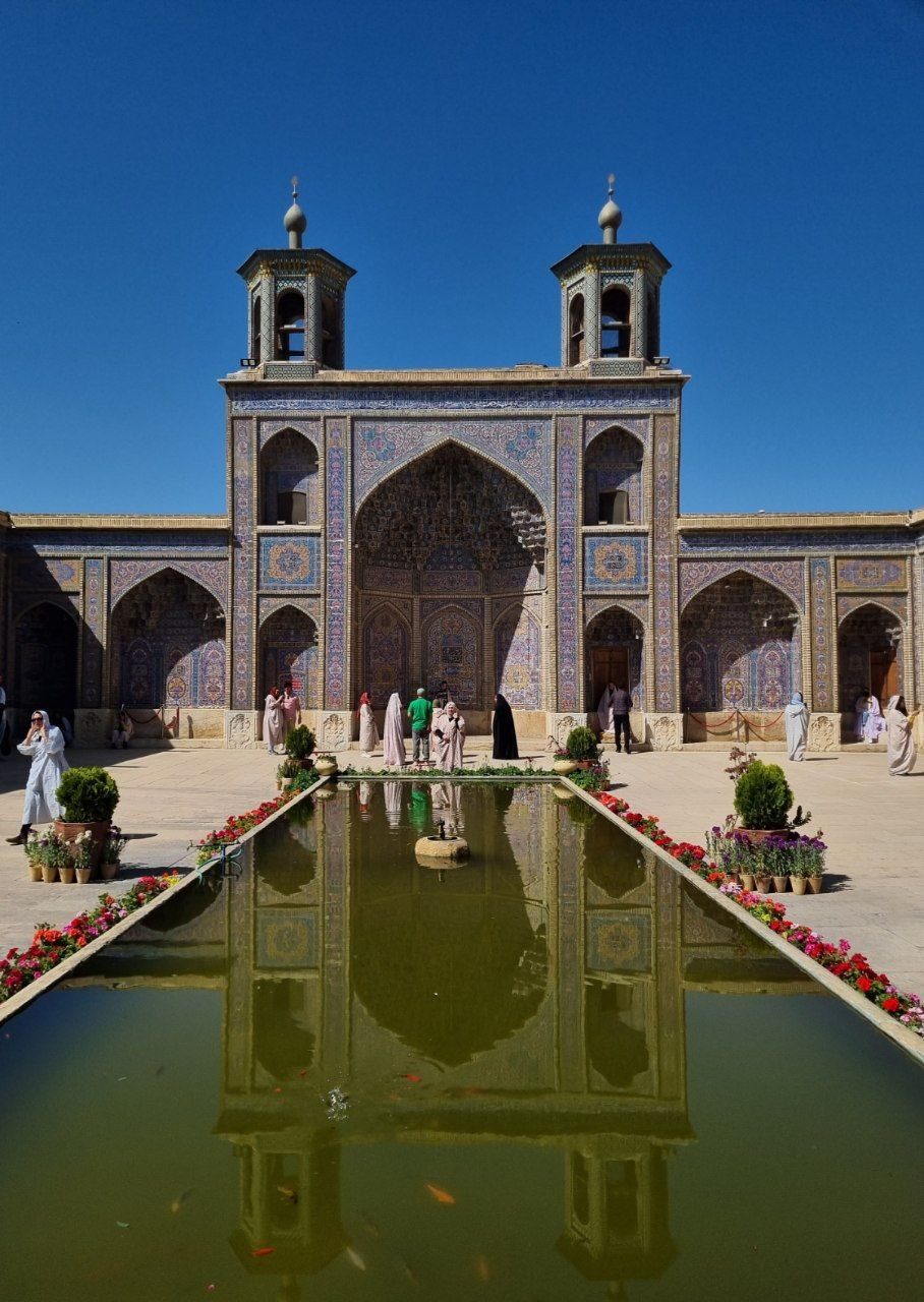 Nasir al-Mulk Mosque — the courtyard facade reflected in the pool.