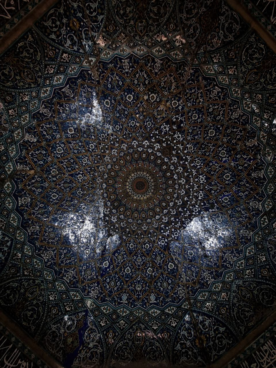 A blue patterned ceiling, photographed from below.