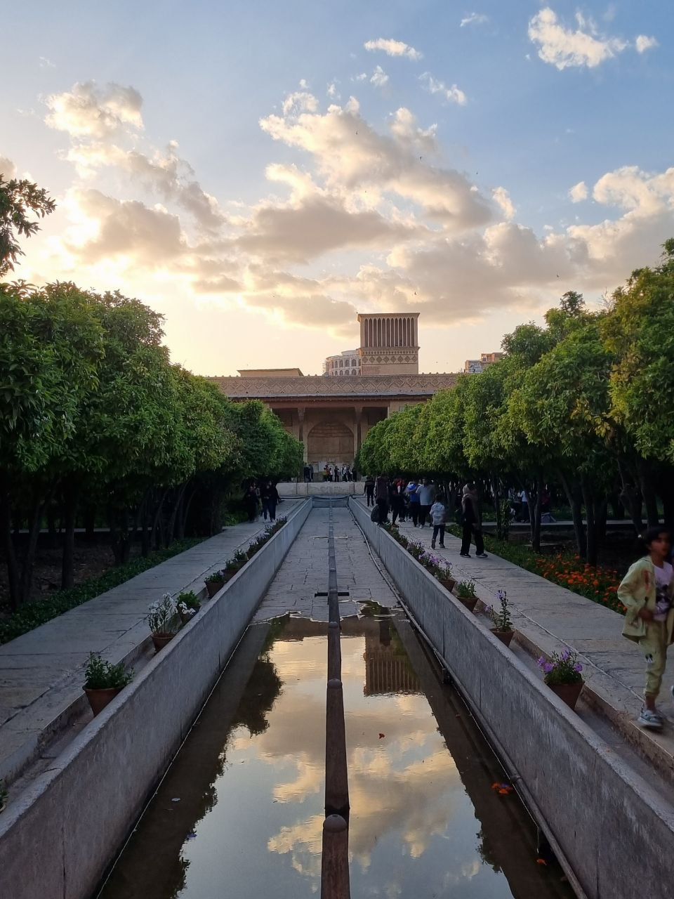 Arg of Karim Khan — water, citrus trees and the windcatcher at sunset.