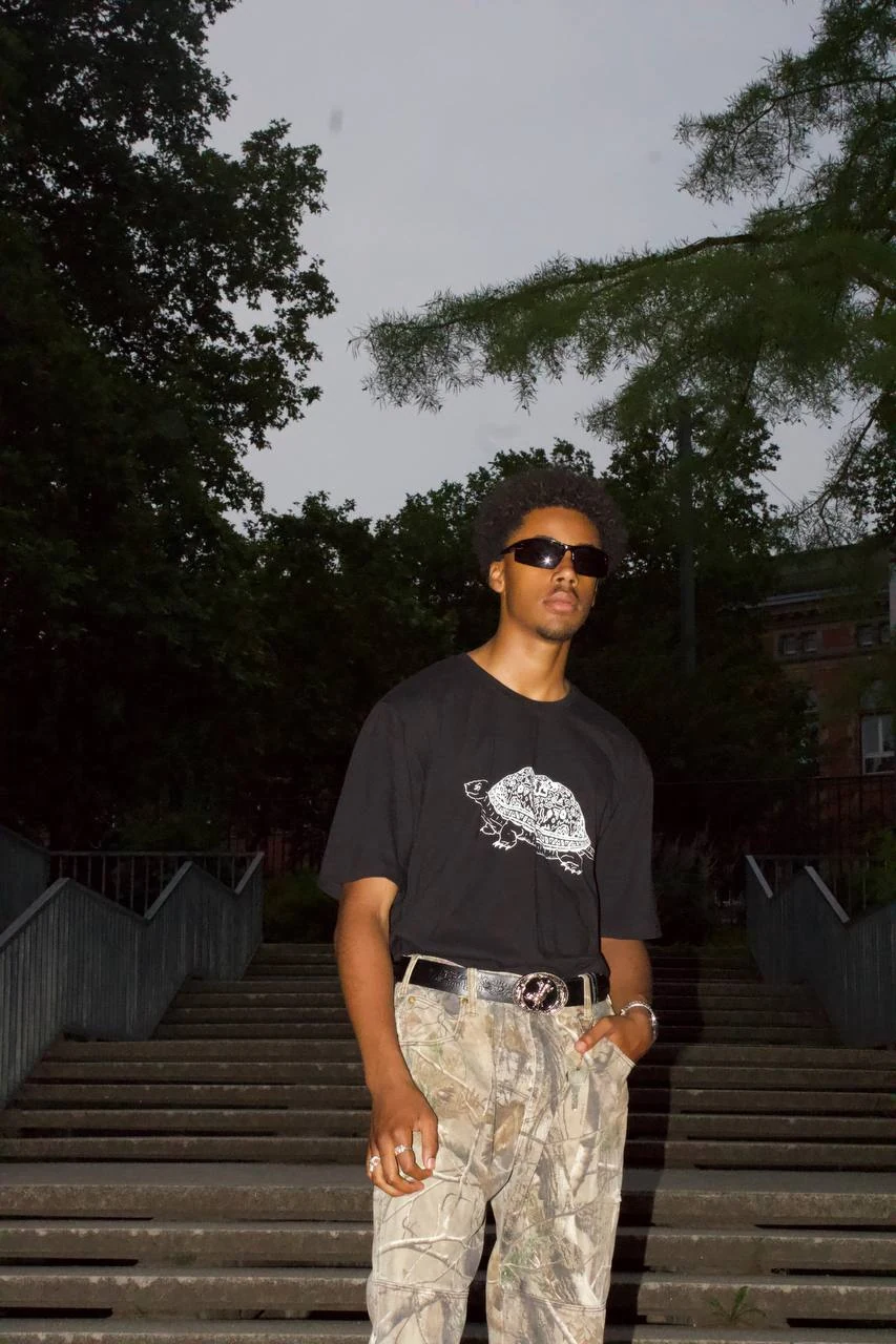 The front graphic worn on a black shirt