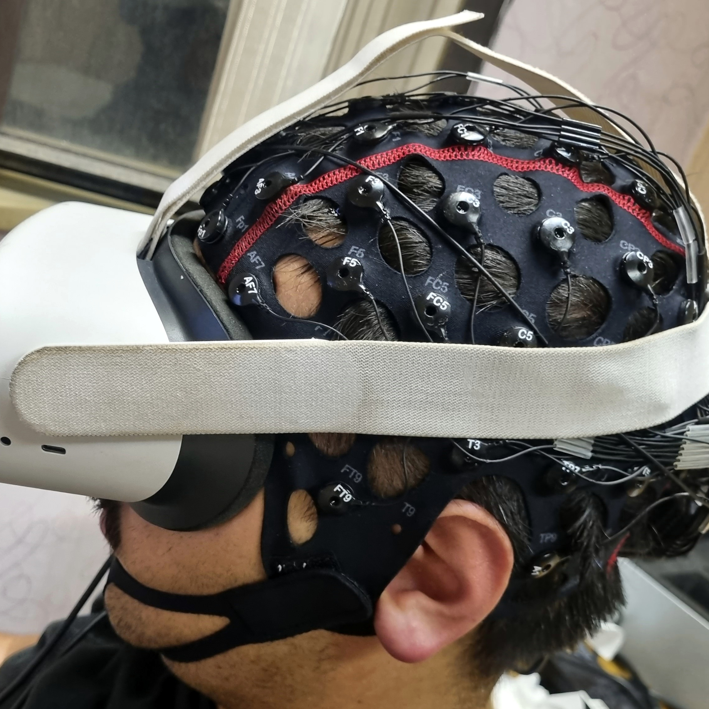 Side view of EEG cap and VR headset worn together
