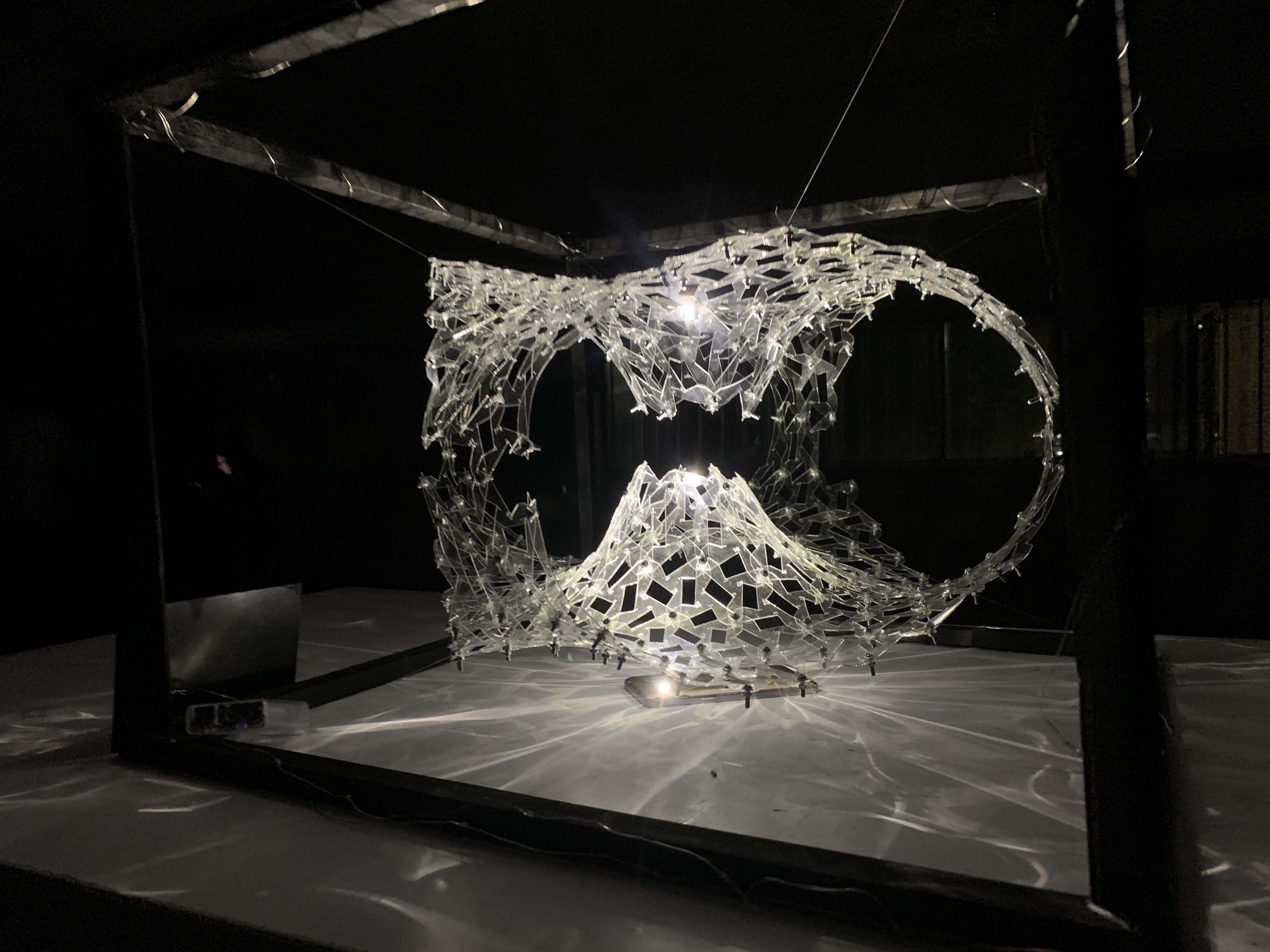 Oblique photograph of the illuminated transparent Wormhole and its two openings
