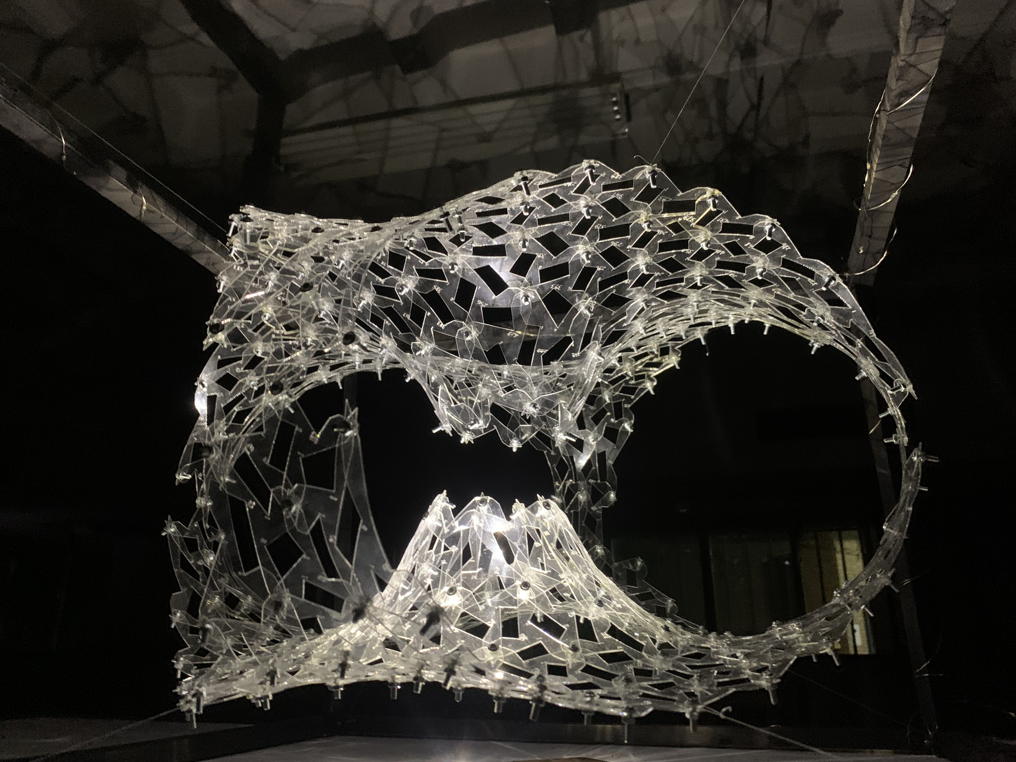 Close view across the transparent Wormhole surface, openings and visible fasteners