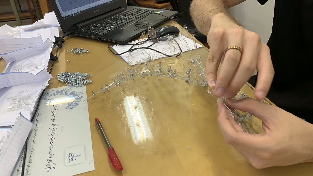 Hands joining transparent parts with metal fasteners